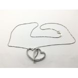 An 18ct white gold twin heart shaped pendant set w