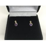 A pair of 9ct gold stud earrings set with a diamon