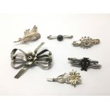 Six silver brooches, various designs.