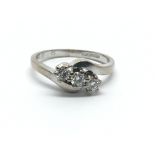 An 18ct white gold, three stone diamond ring, appr