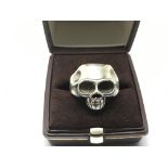 A heavy silver skull ring, approx size 2.