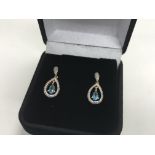 A pair of 9ct gold earrings set with blue topaz an