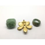 Two jadeite rings and a gold plated flower brooch