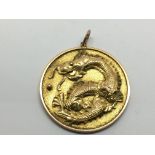 A Chinese gold pendant depicting a dragon with a s