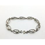 A silver bracelet, the links in the form of dolphi