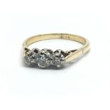 An 18ct yellow gold and three stone diamond ring,