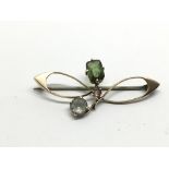 A 9ct gold brooch set with coloured stones, approx