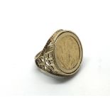 A 9ct gold ring inset with a full sovereign dated