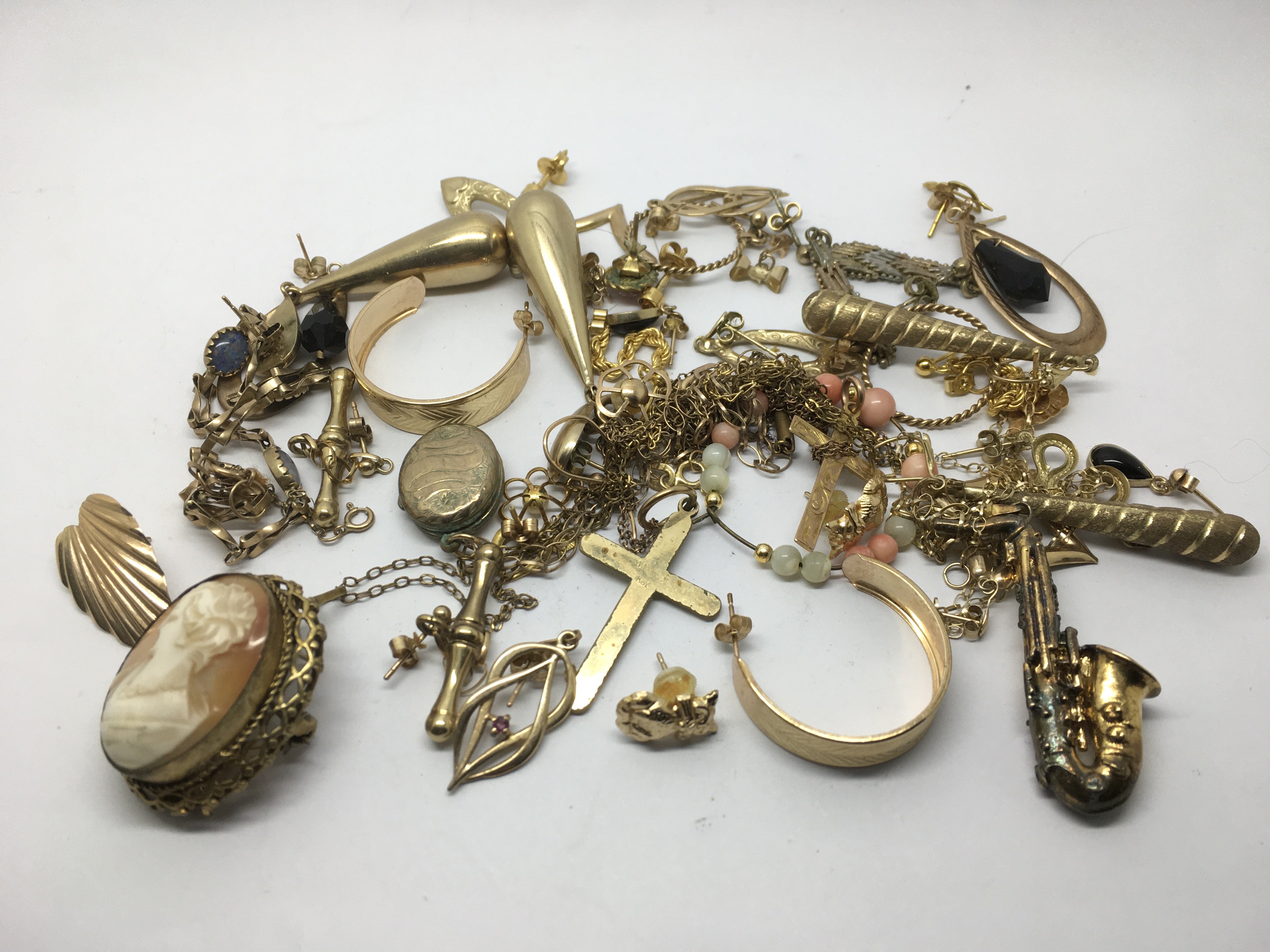 A collection of unmarked gold, gold earrings and o
