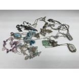 A collection of silver pendants and necklaces