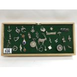 A collection of silver brooches and pendants etc.