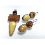 A sterling silver and mixed amber pendant and drop