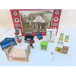 A collection of dolls house accessories and a boxe