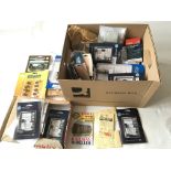 A box of various model railway accessories.