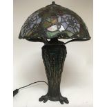 A Tiffany style lamp decorated with Flowers and sp