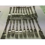 A set of twelve large silver table forks and eight