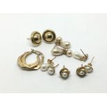 Six pairs of 9ct gold earrings, mostly set with pe