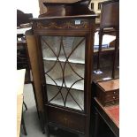 An Edwardian corner cabinet with simulated ribbon