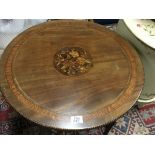 An Edwardian circular occasional table with inlay and banding.