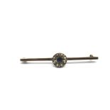 A yellow metal brooch set with blue sapphire and s