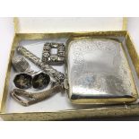 A silver cigarette case and other silver items.