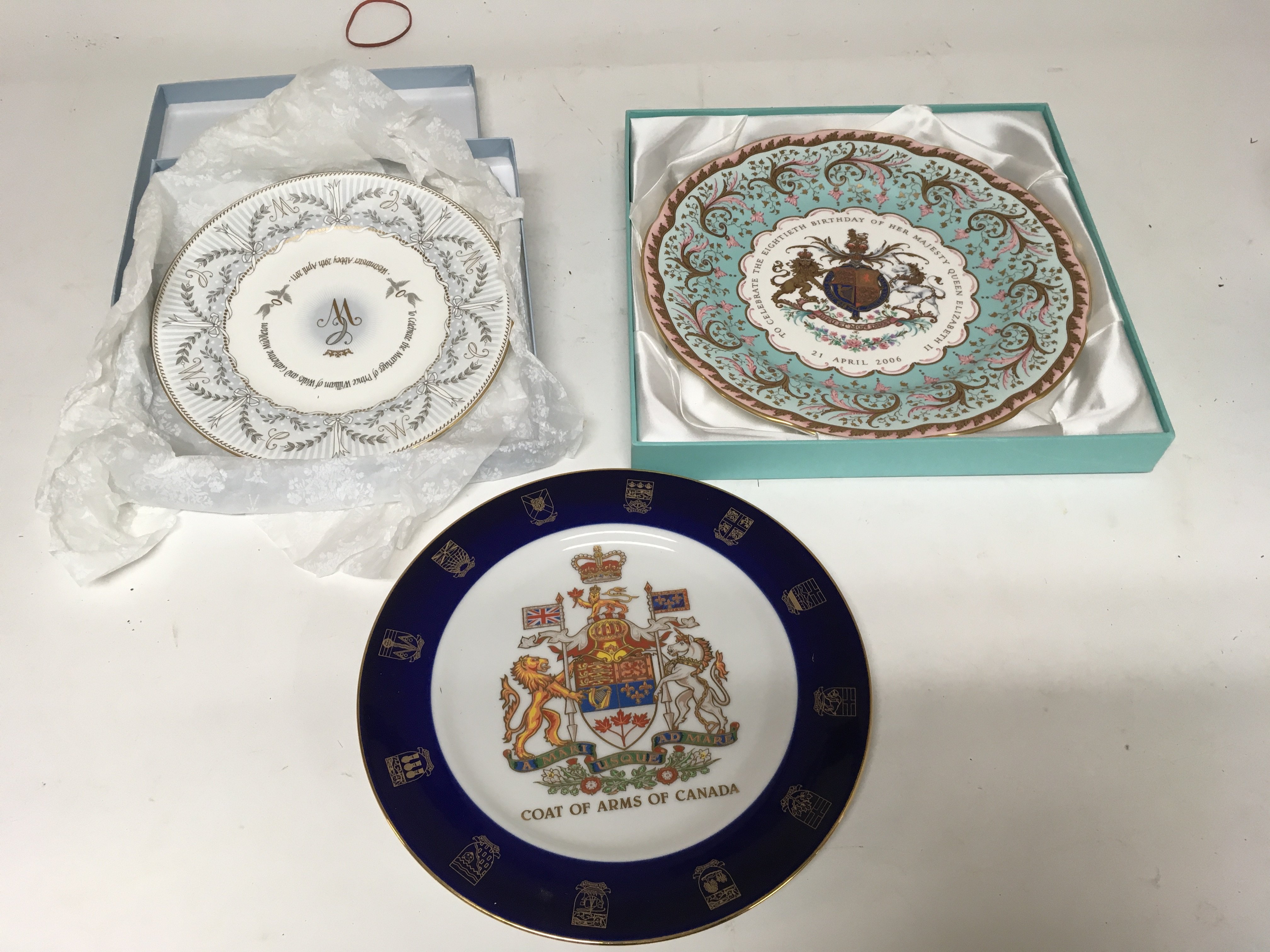A box containing collectors plates and other odd c