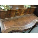 A reproduction Mahogany Carlton house type desk fitted with a flight of drawers and small