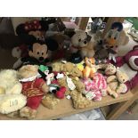 A collection of assorted soft toys including Disne