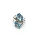 A pair of silver studs set with blue topaz.