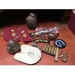 A WW2 era grenade and a small collection of military related artifacts.