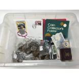 A box of used, mixed coinage.