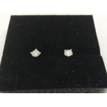 A pair of boxed 18ct white gold claw set RBC diamo