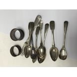 A collection of silver tea spoons and two napkin r