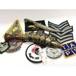 A collection of military cloth badges a small bras