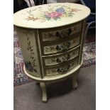 An Italian 20th century hand painted oval flight of drawers with four drawers on scroll legs.