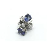 A pair of silver studs set with tanzanite.