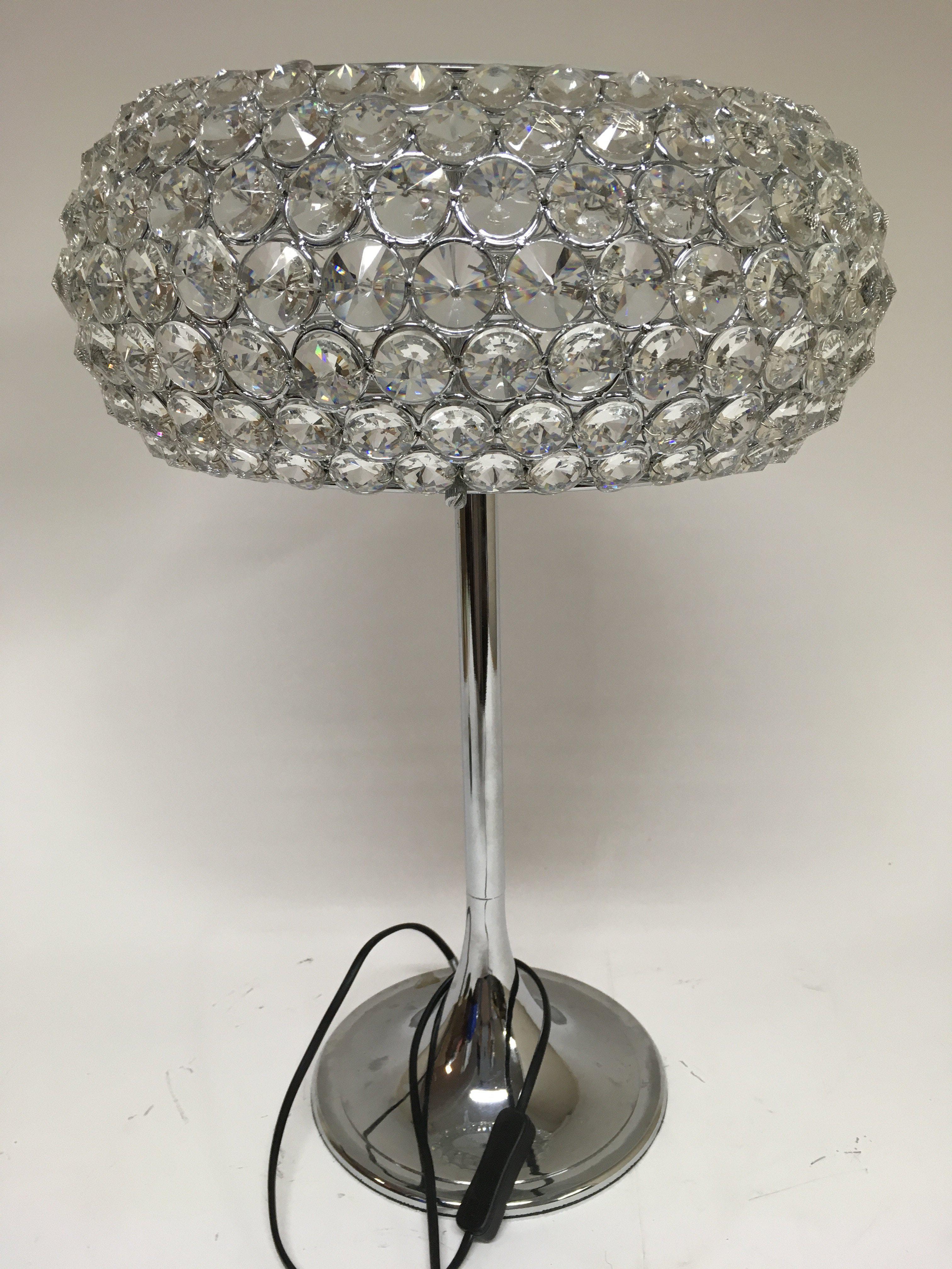 A lamp of modern design, on a circular base. Heigh