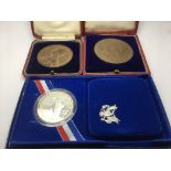 A cased US silver coin and two cased UK commemorat