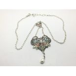 A silver plique-a-jour angel necklace set with a s