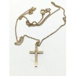 A gold cross on chain, approx 2.5g.