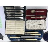 A cased carving set with silver collars together w