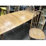 A Ercol Dining table with extra leaf together with