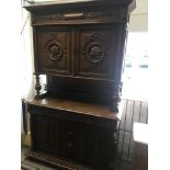 A Victorian oak cabinet with four carved cupboard