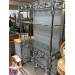 A modern wrought iron and glass open display shelf