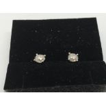 A pair of 18ct white gold diamond solitaire studs,