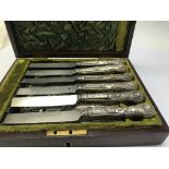 A mahogany case containing knives and forks with s