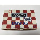 A trade box of KiNSMART 1:72 friction drive diecast cars.