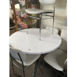 A 1970s White circle kitchen table with four chair