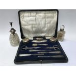 A case containing a silver manicure set and two pe