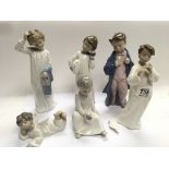 A collection of Lladro and NAO porcelain figures. one with a damaged wing.